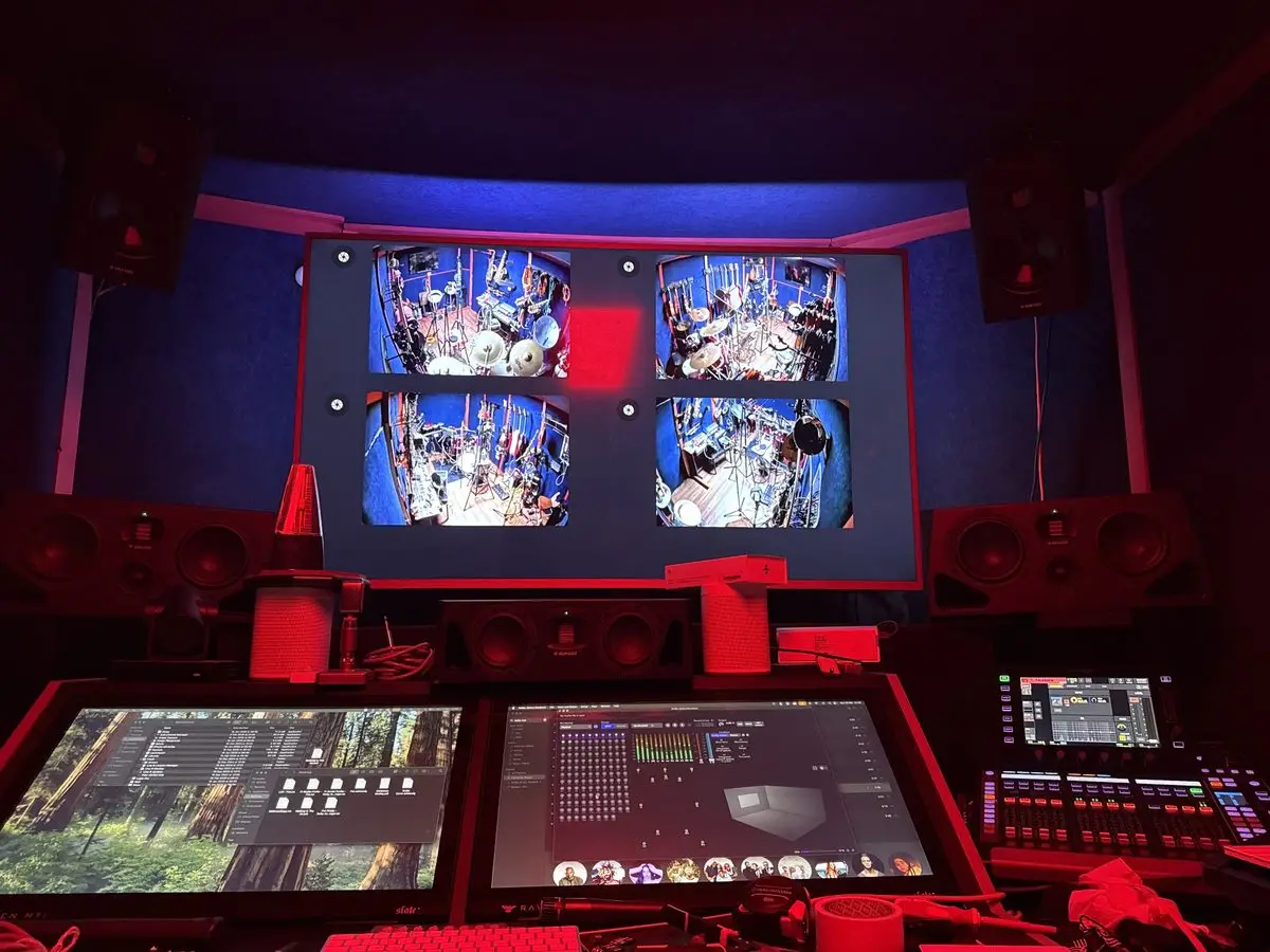 The 4chordsStudios control room with mixing console and live camera feeds