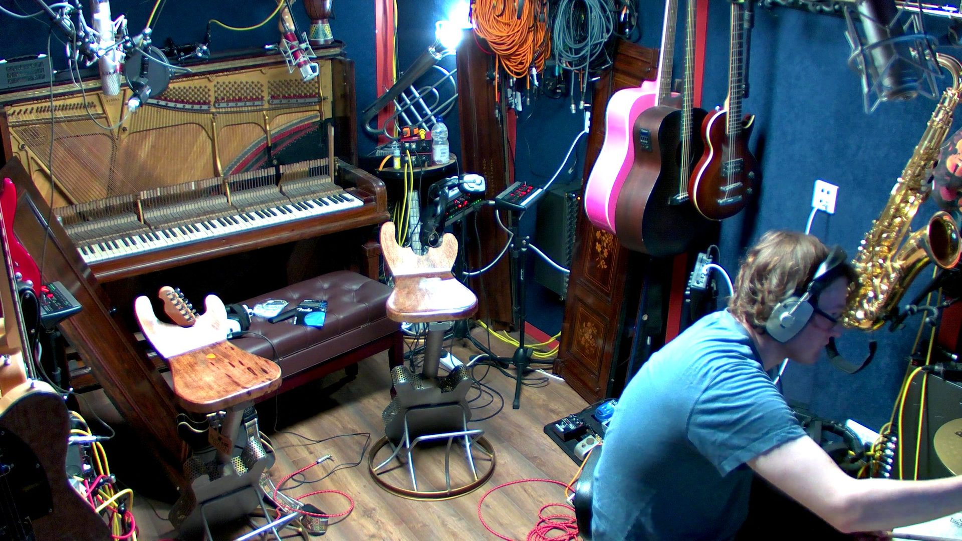 The live room at 4chordsStudios with grand piano and a wall of instruments